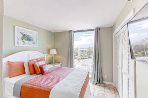 a bedroom with a bed and a large window at Sea Castle A-3 in Myrtle Beach +22 photos
