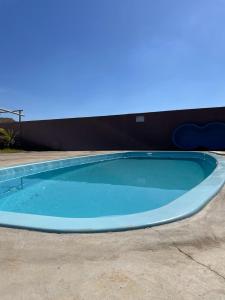 einen großen blauen Pool auf einer Terrasse in der Unterkunft Rancho do Tomate in São Roque de Minas
