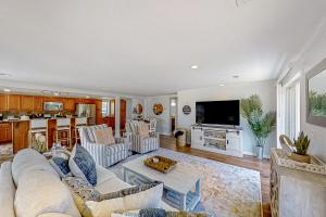 a large living room with a couch and a tv at Lands End in Myrtle Beach