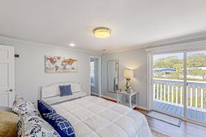 a bedroom with a large bed and a balcony at Lands End in Myrtle Beach