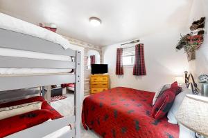 a bedroom with a bed and two bunk beds at Moose Haven in Garden City