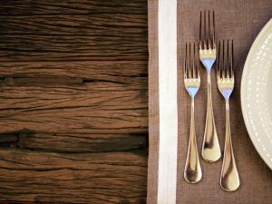 two forks and a plate on a table at Hotel La Pigna in Marina di Pietrasanta
