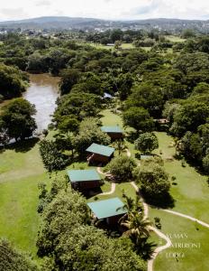 an aerial view of a park with a river and trees at Yumas Riverfront Lodge in San Ignacio