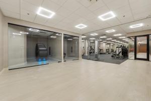 a large room with a gym with a treadmill at Downtown Cozy Apt/EWR/Nyc/Ame Dream Mall/Prud Ctr in Newark