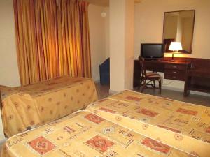 A bed or beds in a room at Hotel Perales