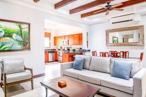 a living room with a couch and a table at Macaw Oceans Club #2 in Jacó