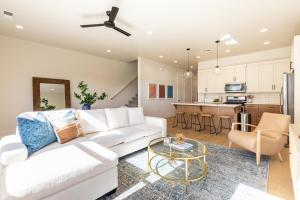 a living room with a white couch and a table at Villa 27 - 4 Bedroom Townhome! Pool and Hot Tub! in St. George