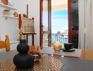a table with vases on top of a table at Beachfront Apartment Nikol in Zaboric