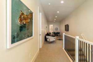 a hallway of a home with a painting on the wall at Villa 28 - 4 Bedroom Townhome! Pool and Hot Tub! in St. George
