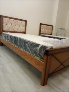 Ce lit se trouve dans un dortoir doté d'un cadre en bois. dans l'établissement Appartement du Sacré cœur, à Alger