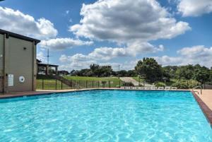 a large blue swimming pool in a yard at Lakeland Casita in Point Venture Optional Golf cart in Lago Vista