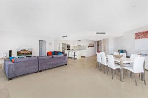 a living room with a couch and a table and chairs at Terrace 4 Kingscliff Oceanfront in Kingscliff +8 photos