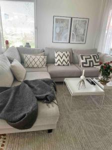 a living room with a couch and a table at Apartments-Malmö Arena-Eurovision Song Contest in Klagshamn