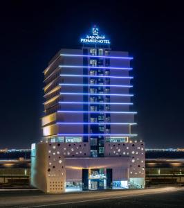 a building with blue lights on it at night at Premier Hotel in Manama