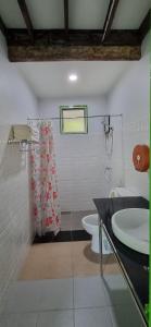 a bathroom with a sink and a toilet at Korp View House in Wang Nam Khieo