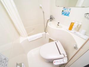 a small bathroom with a toilet and a sink at Super Hotel Tokyo JR Kamata Nishiguchi in Tokyo