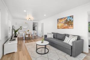 a living room with a couch and a table at ALKI Retreat! Steps-2-BEACH - PARKING in Seattle