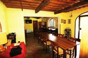 a dining room with a large wooden table and chairs at La Ginestra in Orentano