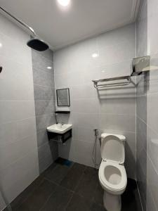 a bathroom with a toilet and a sink at Alia Express Dey Hotel Kota Bharu in Kota Bharu