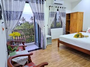 - une chambre avec un lit et un balcon dans l'établissement GREEN TOWN hotel HỘI AN, à Hội An