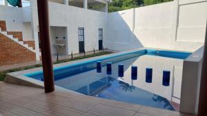 a swimming pool in front of a building at El Rincón Preferido in Papantla de Olarte