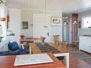a kitchen and living room with a wooden table at 5 person holiday home in VISBY-By Traum in Visby