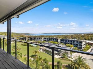 an apartment balcony with a view of a resort at Luxury with lake and hinterland views in Noosa Heads