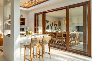 a kitchen and dining room with a table and chairs at Blue Door Villa, Central Canggu in Canggu