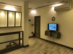 a room with a tv on a wall at Rodex Dahab Studios & Villas in Dahab