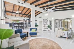 a living room with couches and chairs and a table at Tuckeroo Villa in Edge Hill