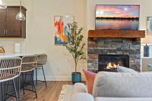 a living room with a couch and a fireplace at Views! LAKE Penthouse- 5 min to Landing & Downtown in Branson