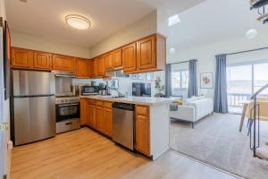 a kitchen with wooden cabinets and stainless steel appliances at Cozy 2BR condo w/ valley views in Vernon Township