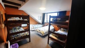 a room with two bunk beds and a room with twounks at Manor house backpackers in Dunedin