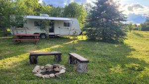 a campsite with a trailer and a picnic table at RV with Rocky Mountains View in McBride