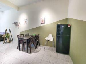 a dining room with a table and a refrigerator at Taiping Homestay Near Lakegarden in Taiping +13 photos