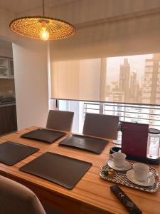 a wooden table with two laptops on top of it at Modern&Nordic Apartament Lomitas (2 ambientes) in Lomas de Zamora