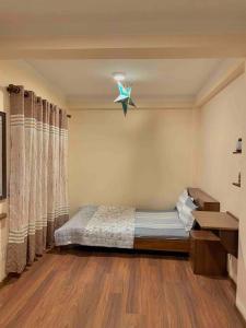a bedroom with a bed and a star on the wall at In the heart of Patan Durbar Square in Pātan