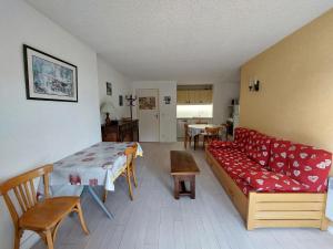 a living room with a couch and a table at Appartement cosy à Autrans, 6 pers, 54m², balcon, proche pistes et commerces - FR-1-737-49 in Autrans