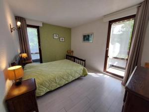 a bedroom with a bed and a large window at Appartement cosy à Autrans, 6 pers, 54m², balcon, proche pistes et commerces - FR-1-737-49 in Autrans