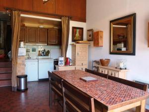 a kitchen with a table with chairs and a counter top at Maison Autrans, 3 pièces, 4 personnes - FR-1-737-41 in Autrans
