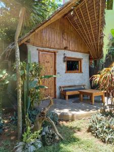 a small house with a bench and a table at Yucca Bungalow in El Nido