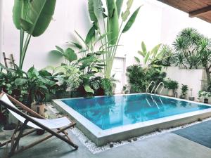 a swimming pool in a room with plants at LaDa's House in Da Nang