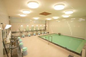a swimming pool in a gymnasium with a pool at Motobu Green Park and Golf Course in Motobu