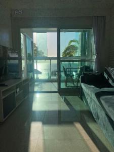 a bedroom with a bed and a view of the ocean at Apto VISTA MAR na Av Contorno in Salvador
