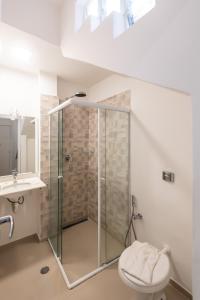 a bathroom with a shower with a toilet and a sink at Happy Sweet Home 3 in Sao Paulo