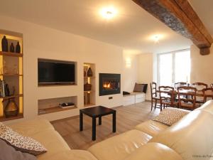 a living room with a couch and a fireplace at Gîte confortable avec animaux, jardin et wifi inclus, cadre paisible en Normandie - FR-1-497-6 in Céaucé