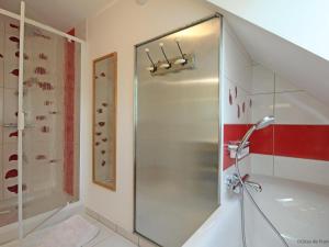 a shower with a glass door in a bathroom at Gîte confortable avec animaux, jardin et wifi inclus, cadre paisible en Normandie - FR-1-497-6 in Céaucé +20 photos