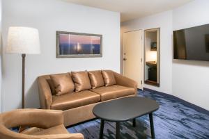 a living room with a couch and a table at Fairfield Inn & Suites Rapid City in Rapid City