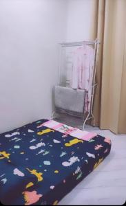 a bedroom with a bed with a blanket with clouds at Homestay D Twinz (2 unit semi d) in Kuala Berang