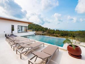 a pool with lounge chairs and a swimming pool at Villa Dila 3 bed Elephant Haven! in Koh Samui